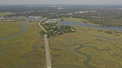 Savannah Georgia Aerial v50 birds eye view capturing vehicles travelling on route 80 highway surrounded by spectacular river creek covered in green algae - October 2020