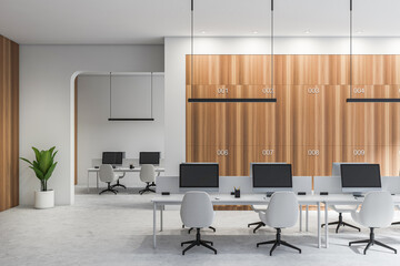 Bright office room interior with desktops, desks, armchairs, plant, arch