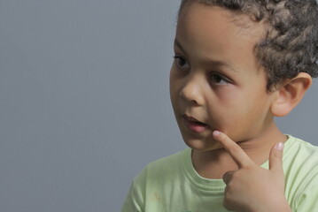 little boy with toothache in pain on grey background stock photo