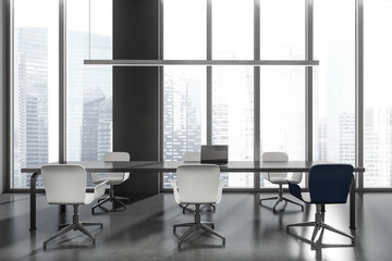 Business room interior with seats, table with laptop. Window with city view