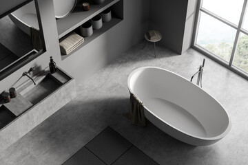 Modern bathroom interior with ceramic bathtub, double sink, mirror. Gray walls, concrete flooring. Panoramic window. Top view. 3d rendering.
