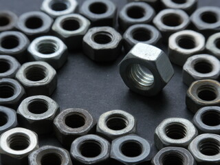 many steel industrial production iron nuts on grey table