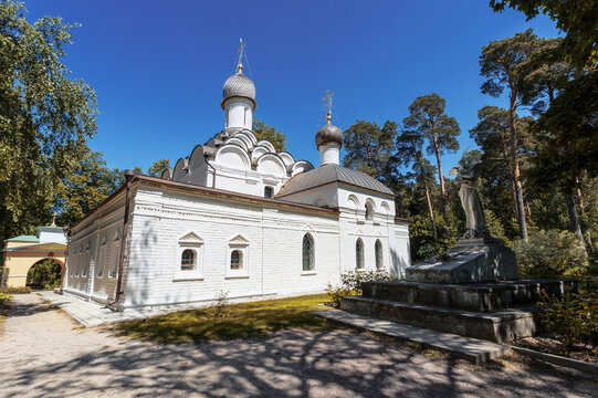 Church of the Archangel Michael and an angel sculpture at the grave of the young princess Tatyana Yusupova in the estate Arkhangelskoe. Moscow region, Russia