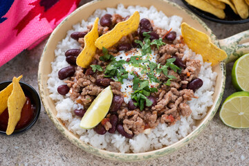 Serving pan with chilli con carne or spicy meat and bean stew with rice, close-up, horizontal shot