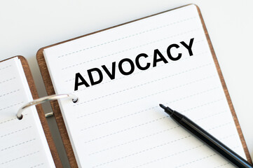 ADVOCACY text on notepad next to black marker, medical concept