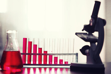 Microscopic examination of blood. Test tubes with red liquid on the laboratory table.