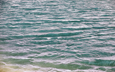 Water surface. The texture of the water. Waves on the lake in windy weather.
