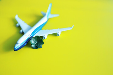 St. patrick's day background. Religious Christian Irish celebration. Four-leaf clover symbol of good luck with airplane.