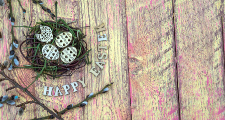 Fototapeta na wymiar Willow twigs. Holy Easter. Red yellow background. Easter eggs in the nest. Happy Easter