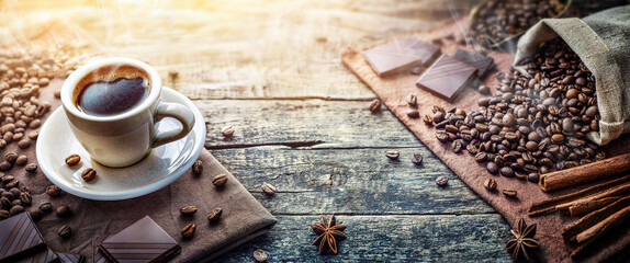 A cup of aromatic morning coffee, zeena coffee, cinnamon, chocolate on the table. Nice background...