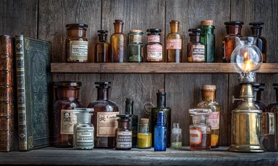 Zelfklevend Fotobehang Bottles with drugs from old medical, chemical and pharmaceutical glass. Chemistry and pharmacy history concept background. Retro style. Chemical substances. © Tryfonov