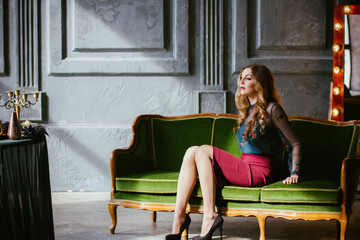 Obraz premium portrait of a young woman with long hair who poses on a sofa