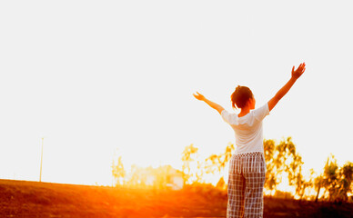 Silhouette side girl looking up Feel rejuvenated by the warm light and sky.