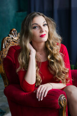 Fototapeta na wymiar portrait of a young woman in a red dress with red lips