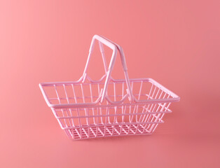 pink basket with a bank card inside. the concept of purchases and sales