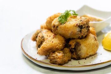 Crispy fried fish sea bass fillets served on plate.