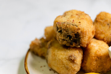 Crispy fried fish sea bass fillets served on plate. 