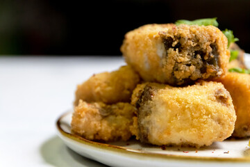 Crispy fried fish sea bass fillets served on plate.