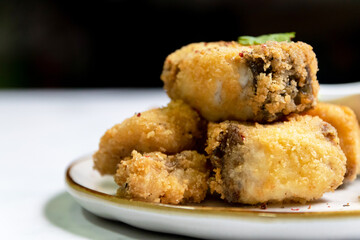Crispy fried fish sea bass fillets served on plate.