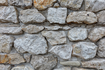 Fragment of an old gray stone wall old gray masonry