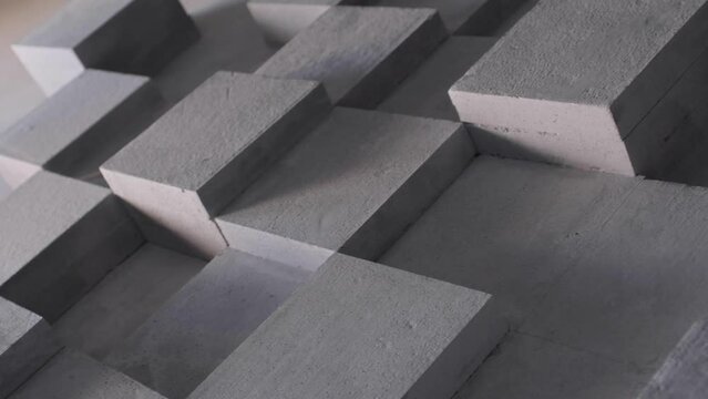 Grey construction background abstract precast concrete texture formed by stone cubes, minimal gray backdrop