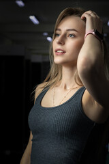 Fototapeta na wymiar Portrait of a young beautiful blonde girl in a sports uniform in the gym.