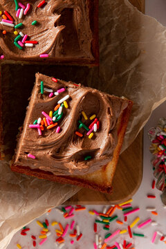 Sponge cake with chocolate frosting, decorated with hundreds and thousands