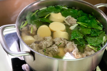 Clear soup with egg tofu, minced pork and ivy gourd in a pot; Thai cuisine.