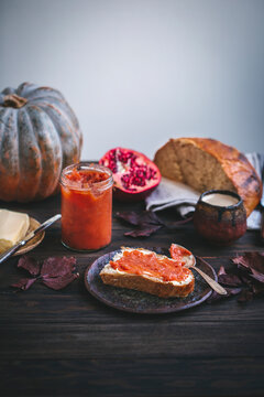 Breakfast scene with rye bread, quince jam and butter
