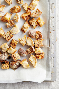 Roasted bread cubes on a baking tray