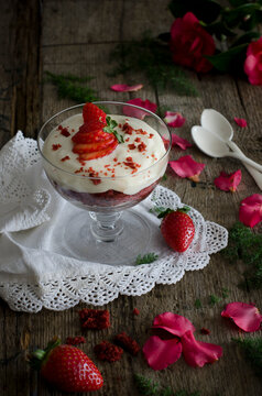 Red velvet trifle with ricotta cream on a rustic wooden table