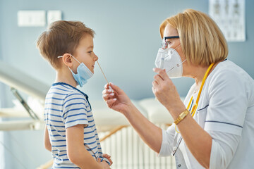 Pediatrician doctor examining little kids in clinic