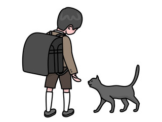 猫と遊んでいる大きなランドセルを背負った入学したばかりの男の子