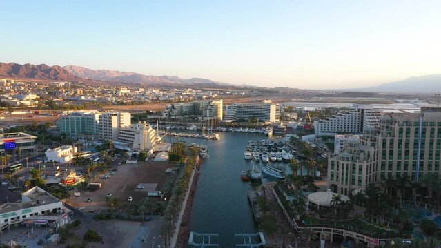 Aerial view of Eilat city, resorts, hotels, yachts and marina during golden hour