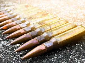 Closeup old rifle bullets on cement floor with blurred background. Soft and selective focus. vintage bullets collections concept.