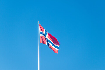 National flag of Kingdom of Norway on blue sky.