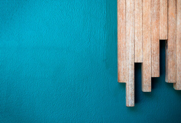 Close up minimal style background with a row of wood sticks arranged as a chart step on the blue color concrete wall surface with copy space.