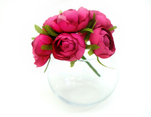 Artificial flower and glass vase on white background, wedding interior detail close up