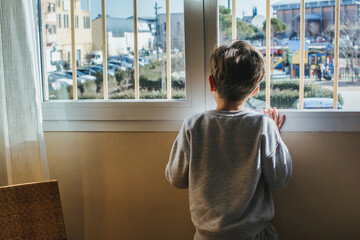 Portrait Of An Adorable Little Boy Looking Out The Window 