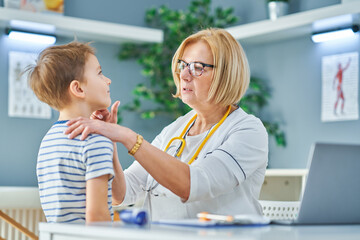 Pediatrician doctor examining little kids in clinic