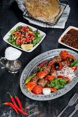 turkish kebab, salad, lavash, buttermilk, on the dark bacground