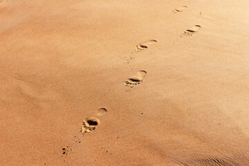 Footprints on beach sand, background or texture