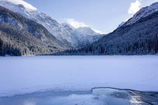 The 'J&auml;gersee' lake frozen during wintertime and covered with snow blanket (Kleinarl, Austria)