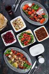 turkish onion kebab, salad, lavash, buttermilk , appetizers on the dark bacground 
