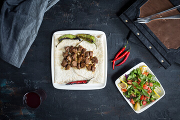 turkish sis kebab, salad, lavash, buttermilk, on the dark bacground