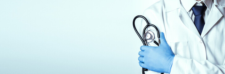 Stethoscope doctor medical background. Happy nurse in hospital uniform, blue gloves holding stethoscope isolated on white. Medicine service and healthcare concept.