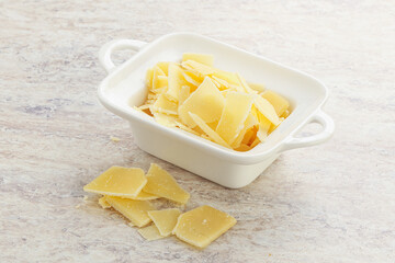 Sliced parmesan cheese heap in the bowl