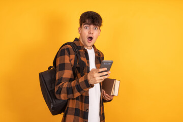 surprised student with mobile phone isolated on background