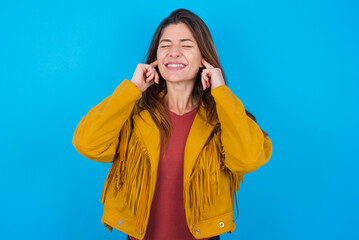 Stop making this annoying sound! Unhappy stressed out young caucasian woman wearing yellow fringed...