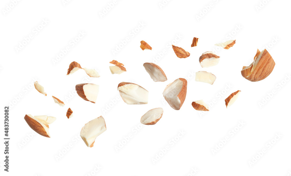 Wall mural pieces of tasty almonds on white background